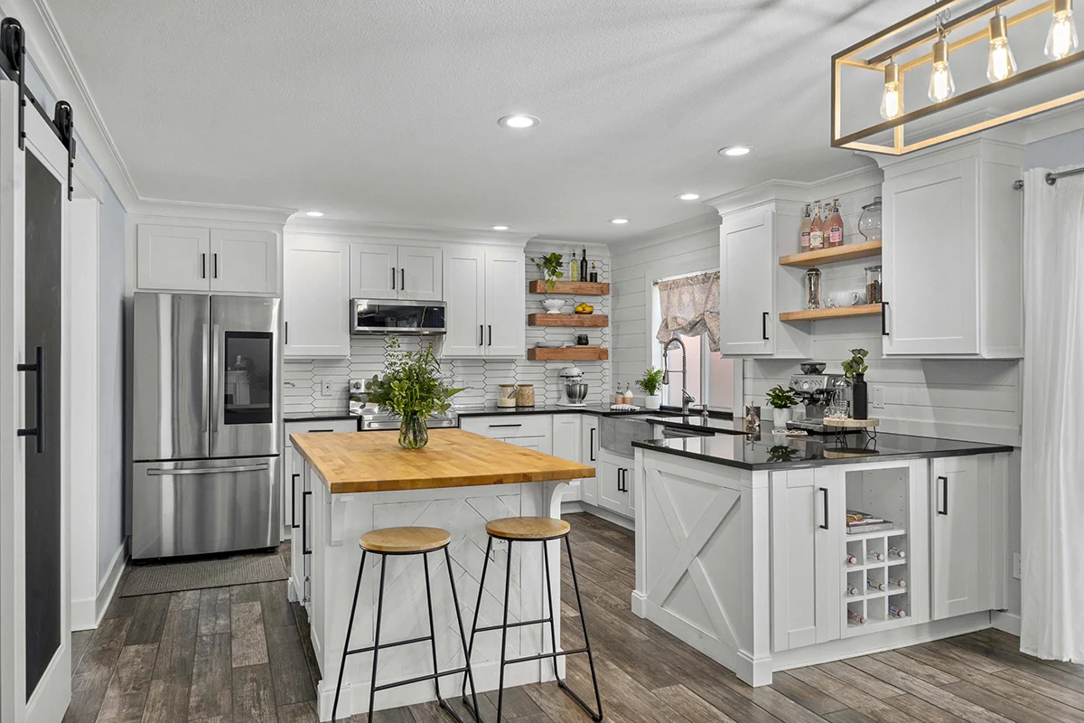 Remodeled kitchen with white cabinetry and light finishes