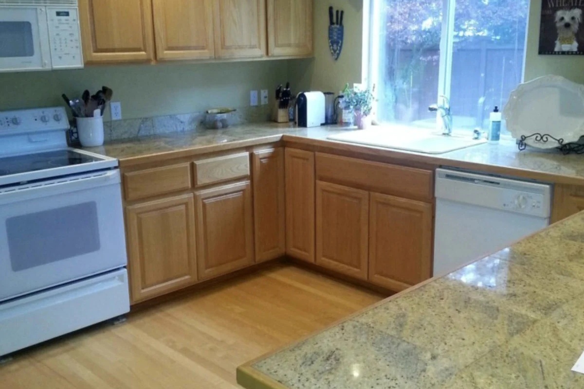 Kitchen before renovations with original wood cabinetry